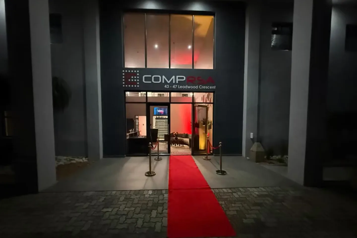 The COMPRSA office entrance in Port Elizabeth with a red carpet at night